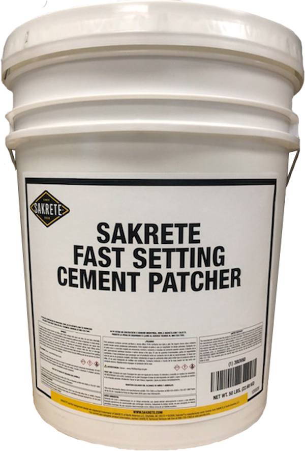 White plastic bucket labeled 'SAKRETE Fast Setting Cement Patcher' containing cement patching material for repairs at a job site